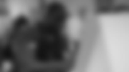 Defensive lineman Michael Dogbe intently paints during Tuesday night's Crucial Catch event for the Cardinals and cancer survivors.