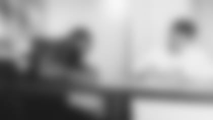 New Cardinals cornerback Malcolm Butler signs his contract with team owner Michael Bidwill on Tuesday.