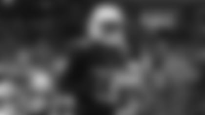 Running back Stevie Scott runs on the field before the preseason game against the Broncos.