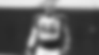 Linebacker Terrell Suggs makes a face reacting to a teammate's uniform choice before Saturday's training camp practice.