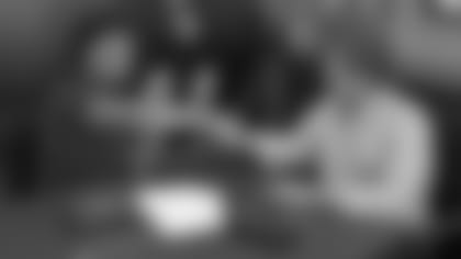 Rookie first-round pick Kyler Murray shakes the hand of team president Michael Bidwill after Murray signed his first NFL contract Thursday.