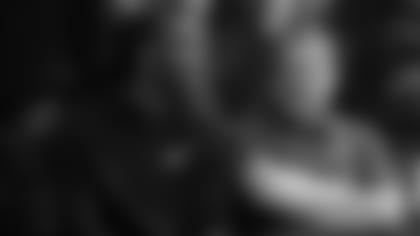 Larry Fitzgerald and Suns owner Robert Sarver attend a basketball game at the University of Arizona in 2017.