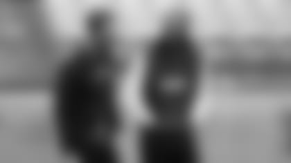 Coach Kliff Kingbury (left) and wide receiver Larry Fitzgerald share a laugh during the Cardinals' conditioning test Wednesday as the team opened training camp.