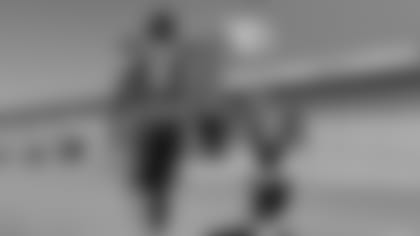 Tennyson Erickson (right) walks with WR Larry Fitzgerald during his visit to the Cardinals in 2018.