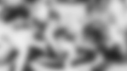 Cardinals Budda Baker (3), Isaiah Simmons (9) and Leki Fotu (95) gang-tackle in Seattle.