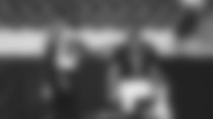 Linebacker Chandler Jones (left) and quarterback Kyler Murray share smiles before a training camp practice.