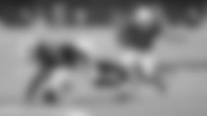 Wide receiver Christian Kirk (13) runs with the ball downfield after a catch while teammate Larry Fitzgerald delivers a big block.