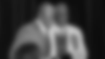 Cardinals scout Malik Boyd (left) receives his award Friday from Charles Garcia of the Fritz Pollard Alliance.