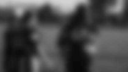 Cardinals linebacker Markus Golden gets ready to toss a coin before a girls' flag football game on Thursday evening.