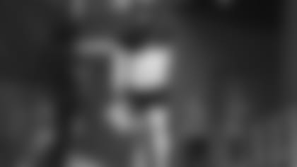 Cardinals quarterback Kyler Murray runs on to the field before Saturday's Red and White Practice.