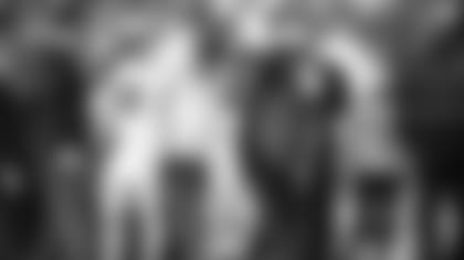 Wide receiver Marquise Brown is helped off the field bu athletic trainers Chad Cook (left) and Tom Reed (right) in Seattle last weekend.