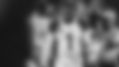 A dejected Kyler Murray walks off the field following the Cardinals' playoff loss against the Rams Monday night.