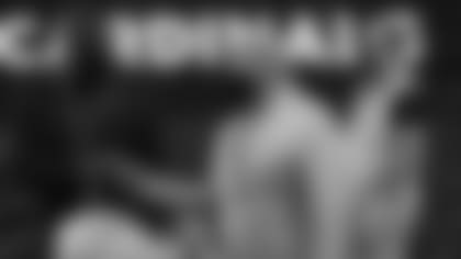 Cardinals GM Steve Keim (right) fistbumps VP of pro personnel Adrian Wilson before a home game in 2020.