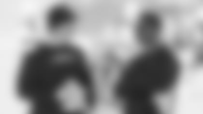 Newly promoted director of college scouting Josh Scobey (right) talks with director of player personnel Dru Grigson during last month's rookie minicamp.