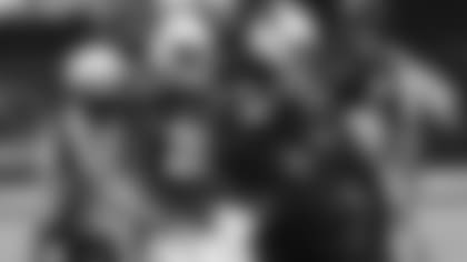 Head athletic trainer Tom Reed (right) helps cornerback Dre Kirkpatrick (20) off the field during a game in 2020 after an injury.