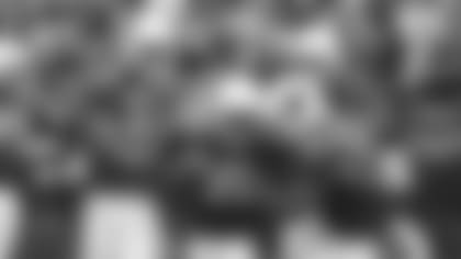 LaRod Stephens-Howling (middle) gets the ball back from Adrian Wilson (24) and props from Jason Wright (31) after scoring on his 102-yard kickoff return.