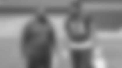 Cardinals defensive assistant Chris Wilson (left) and son/tight end Caleb Wilson have a laugh prior to a recent practice.