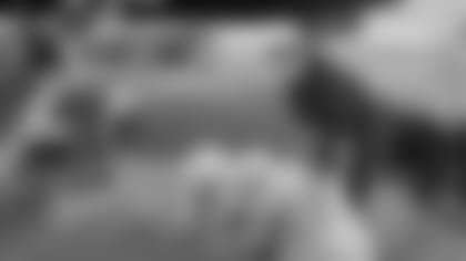 Alex Temes of Gwinnett Fire & Emergency Services picks up the FIDO bags at the airport after the Cardinals' charter plane landed Saturday afternoon.