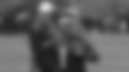 Quarterback Kyler Murray throws a pass as coach Kliff Kingsbury looks on during a practice this offseason.