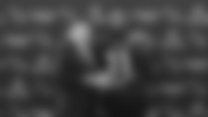 Team chairman and president Michael Bidwill (left) presents running back David Johnson with the 2019 Cardinals Walter Payton Man of the Year award.