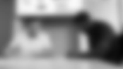 Cardinals RB David Johnson (right) signs his three-year extension with team president Michael Bidwill