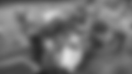 Teammates swarm wide receiver Larry Fitzgerald after his game-winning touchdown Saturday night in a 26-20 defeat of the Packers, putting the Cardinals in the NFC Championship.