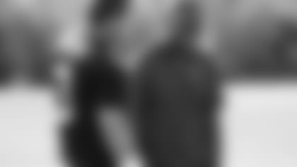 Coach Byron Leftwich (right) has a laugh with QB Carson Palmer.