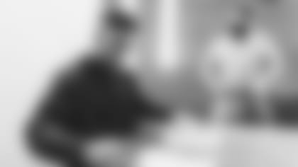 New Cardinals running back James Conner signs his contract Tuesday morning alongside director of football administration Matt Harriss.