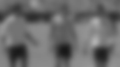 Cardinals quarterbacks (from left) Brett Hundley, Charles Kanoff and Josh Rosen talk during the opening day of voluntary workouts on Monday.