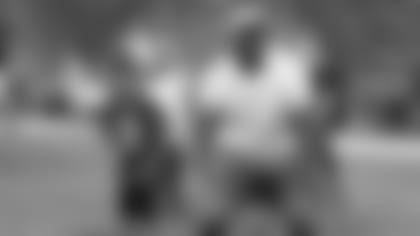 Chandler Jones gets ready to give a handoff Saturday during his kids' camp in Tempe.