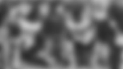 Chicago Bears outside linebackers coach Brandon Staley studies a Microsoft Surface Tablet with linebackers Willie Young (97), Isiah Irving (47), Lamarr Houston (99) and Leonard Floyd (94) on the sideline during an NFL preseason game against the Arizona Cardinals, August 19, 2017 in Glendale, Ariz. The Bears defeated the Cardinals 24-23. (Kevin Terrell via AP)