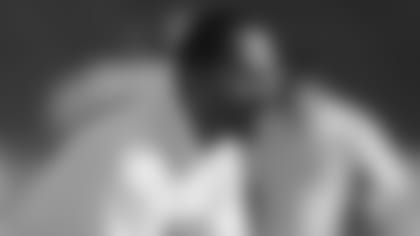 Kansas City Chiefs defensive backs coach Tony Dungy warms his players up before a 1991 NFL game.