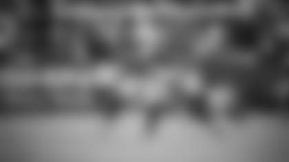 Two Dallas defenders attempt to bring down Cam Sims.