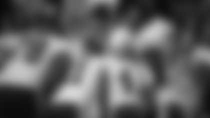 Alex Smith calls a play in the huddle during the Washington Football Team's game against the Detroit Lions. (Zack Silver/NFL)