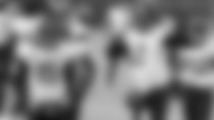 Jacksonville Jaguars quarterback Mike Glennon adjusts his helmet while working out prior to an NFL football game against the Baltimore Ravens, Sunday, Dec. 20, 2020, in Baltimore. Quarterback Gardner Minshew II (15) looks on. (AP Photo/Gail Burton)