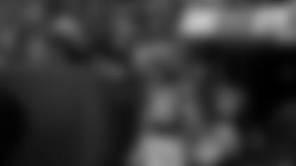 Packers RB Jamaal Williams and LB Oren Burks greet fans as they head into the locker room after Sunday's 20-15 victory over the Washington Redskins.