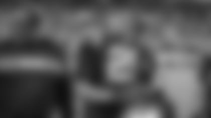 Eric Reid smiles on the sideline