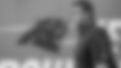 Ron Rivera walks past Keep Pounding sign