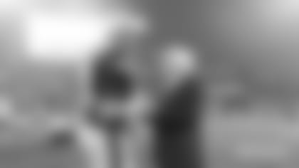 Patriots Chairman and CEO Robert Kraft talks with quarterback Mac Jones (10).