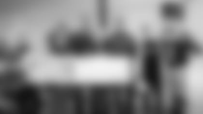 The Patriots Foundation presented Families in Transition-New Horizons for New Hampshire (FIT-NH) with a $2,500 donation, made possible by the Patriots decal stickers for New Hampshire decal license plates. Pictured from left to right are Patriots cheerleader Victoria M.; Stephanie Savard, interim executive leader and chief operating officer at FIT-NH; former Patriot Max Lane; Mary Silva, volunteer and in-kind donation manager at FIT-NH; former Patriot Ilia Jarostchuk; Patriots cheerleader Steven, and mascot, Pat Patriot.