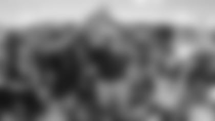 Ernie Adams (center) leads the team in a final huddle before his retirement.