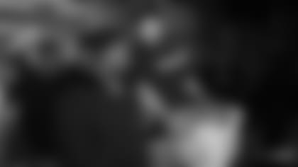 David Andrews walks a family and their "Thanksgiving in a Basket" out to their car at Morgan Memorial Goodwill in Boston.