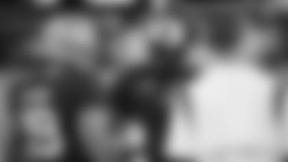 West head coach and New England Patriots wide receiver and kickoff returners coach Troy Brown, center, speaks with players during the first half of the East-West Shrine Bowl NCAA college football game Thursday, Feb. 2, 2023, in Las Vegas.