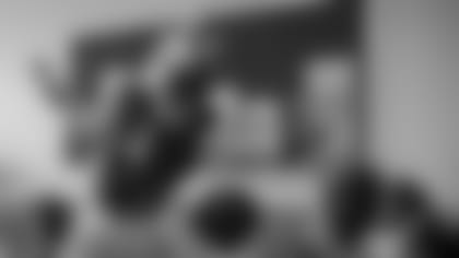 Raider Rusher high-fives students as they head to the multipurpose room for breakfast.