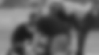 Baltimore Ravens head coach John Harbaugh, right, looks over Baltimore Ravens running back J.K. Dobbins (27) as he lays on the ground after suffering an injuring during the first half of a preseason NFL football game against the Washington Football Team, Saturday, Aug. 28, 2021, in Landover, Md.