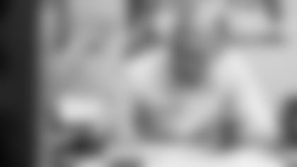 General Manager Eric DeCosta watching film and taking notes.