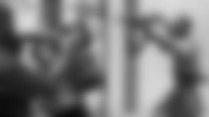 Older rebel fighters wrestle the gun from a young fighter caught looting with it. (left) A fighter from the National Patriotic Front of Liberia runs and shoots during an offensive on the frontline in Monrovia. (right) (AP Photos/ Ben Curtis & Jean-Marc Bouju)