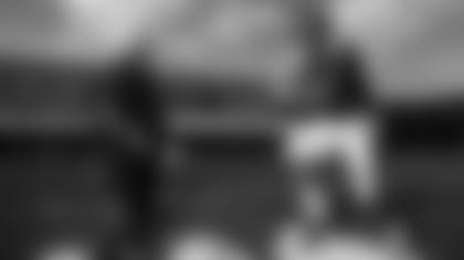 Running back coach Thomas Hammock runs drill with RB Gus Edwards at Ravens Training Camp