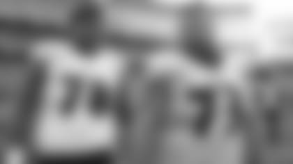 Orlando Brown Jr. and Marshal Yanda warm up before an NFL game.