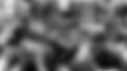 The defense makes a group tackle